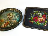 two trays with flowers on them sitting on a table