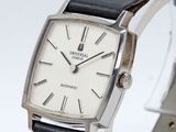 a close up of a wrist watch with a white dial