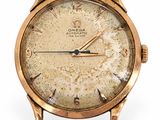 une image d'une montre en or avec un bracelet en cuir marron