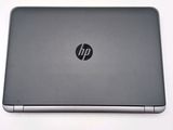 the back of a laptop with a silver hp logo on the screen