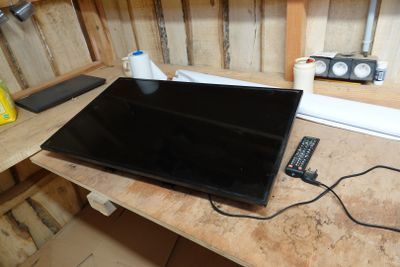 a laptop computer sitting on top of a wooden desk