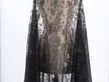 an image of a black and white lace cape on a mannequin
