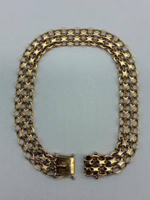 a gold chain bracelet with two clasps on a white background