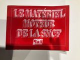 a red sticker with the words rail on it