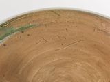 a close up of a brown bowl with writing on it