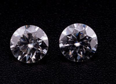 une paire de diamants taille ronde sur un fond noir