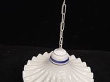 an image of a white and blue lamp hanging from a chain