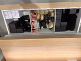 many pairs of shoes that are on display in the store