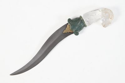 a knife that is laying on a white surface