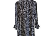 a black and white leopard print shirt dress on a hanger