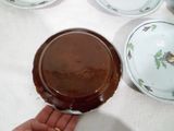 a person holding a plate with a chocolate cake on it