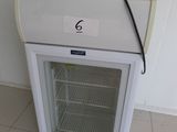 a white refrigerator with a glass door in a room