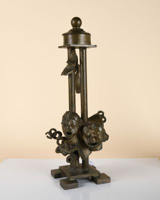 an old bronze statue of a man on a pole with a bird on it