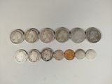several different coins are arranged in a row on a white surface
