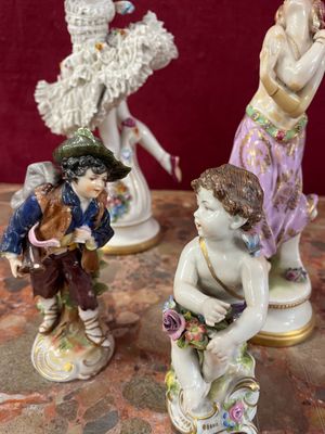 three figurines of a boy and a girl on a table