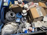 a blue bin full of assorted electronics and other items