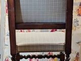 a chair that is sitting in front of a wallpapered wall