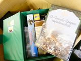 a box full of books and dvds on a table