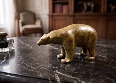 a statue of a bear sitting on a marble table