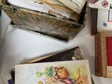 a basket full of books on a table next to a pile of other books