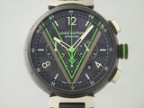 un gros plan d'une montre au cadran noir et aux aiguilles vertes