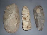 three pieces of rock sitting on top of a table next to each other
