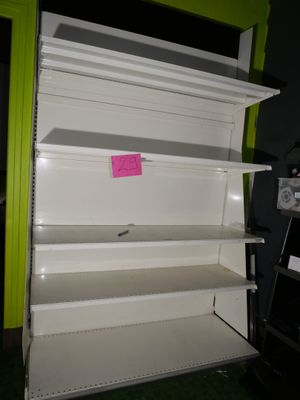 a white shelf that has a pink sticker on it