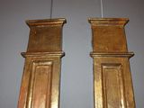 two wooden pillars on the wall next to each other