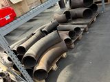 many pipes that are sitting on a shelf in a warehouse