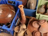 many different types of vases and containers on the floor