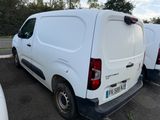 two white vans parked in a lot next to each other