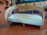 a couch that is sitting on a tile floor in a room