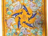 a yellow scarf with blue birds and flowers on it