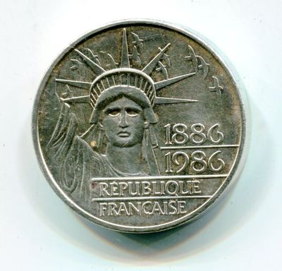 an image of a coin with the statue of liberty on it