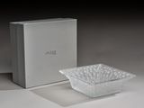 a glass bowl sitting next to a box on a table