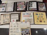 a lot of stamps on a table with a book open