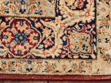 a close up of a rug on a wooden floor next to a wall