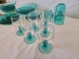a lot of glassware on a table with a white table cloth