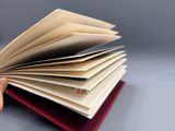 une personne tenant un livre ouvert sur une table