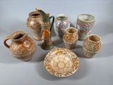many vases and plates that are sitting on a table