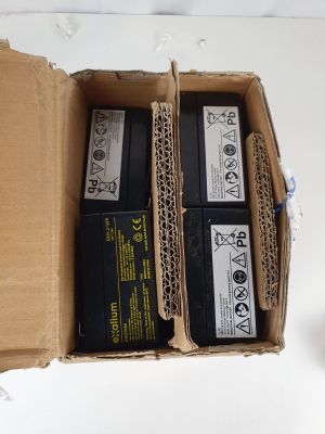 two batteries in a cardboard box on a white table