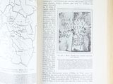 a person holding an open book with a map on it
