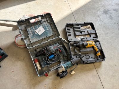 a tool box with tools on the floor next to a hammer
