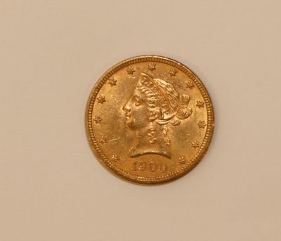 a close up of a gold coin with a woman ' s head on it