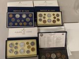 four boxes of coins are sitting on a counter top