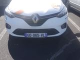 a white car parked in a parking lot next to a silver car