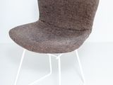 the chair is made of wool and has a white metal frame