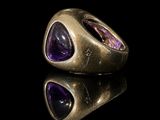 a close up of a gold ring with amethorate and amethorate