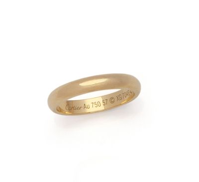 a close up of a gold ring on a white background
