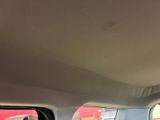 a man sitting in the back seat of a car looking out the window